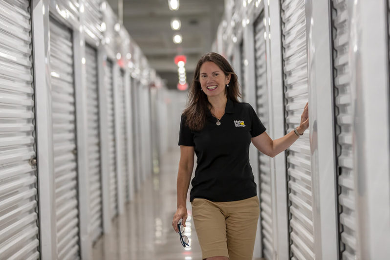 Woman walking in front of storage units.