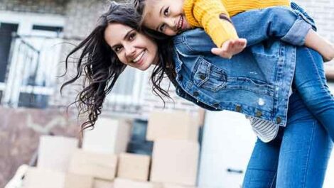 Child sitting on his mother's back.