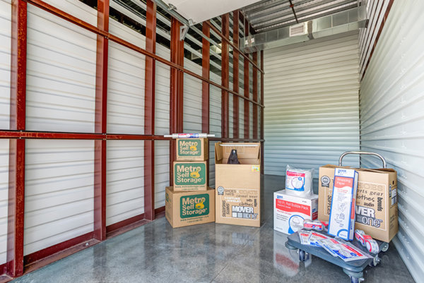metro self storage drive up storage unit with moving boxes and cart