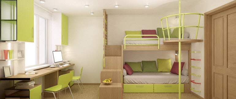 A green and white dorm room with bunked beds and a desk set up