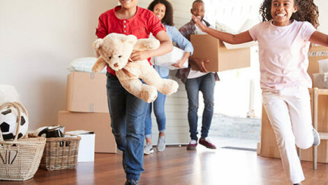 Family moving boxes into their new house.