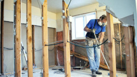 A man in a respirator renovating a house.