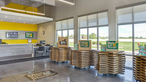 A view of the inside of a Metro Self Storage office. There are boxes for sale next to the main counter.