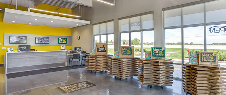 A view of the inside of a Metro Self Storage office. There are boxes for sale next to the main counter.