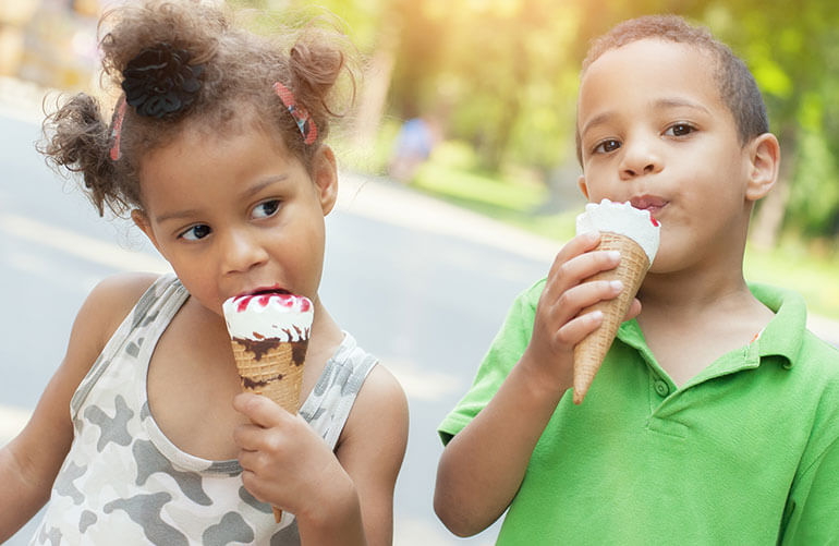 Children eating ice cream cones from The Original Rainbow a south side Chicago neighborhood eatery