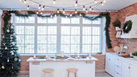 view of a kitchen decorated with lights and a Christmas tree