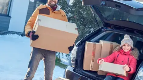 Father and daughter moving in the snow.