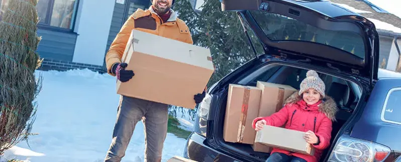 Father and daughter moving in the snow.