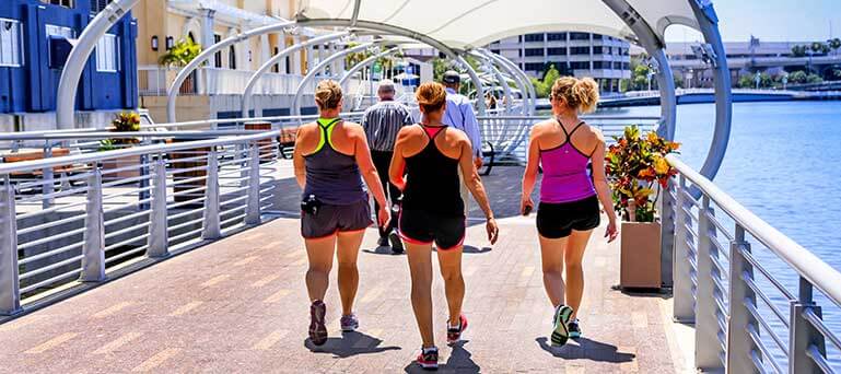 Group of women walking along the Riverwalk in Tampa, Florida