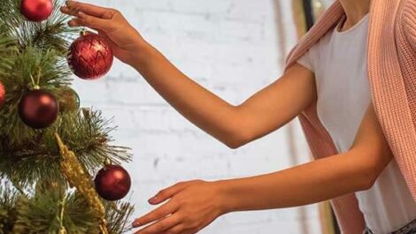 A woman taking down holiday decorations