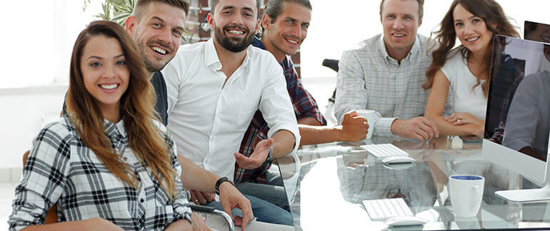 Friends sitting at a desk.