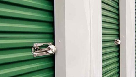 a row of green self storage garage doors with locks installed