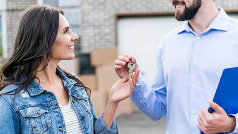 Man handing a woman a key.