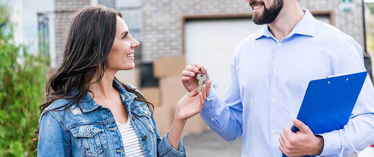 Man handing a woman a key.