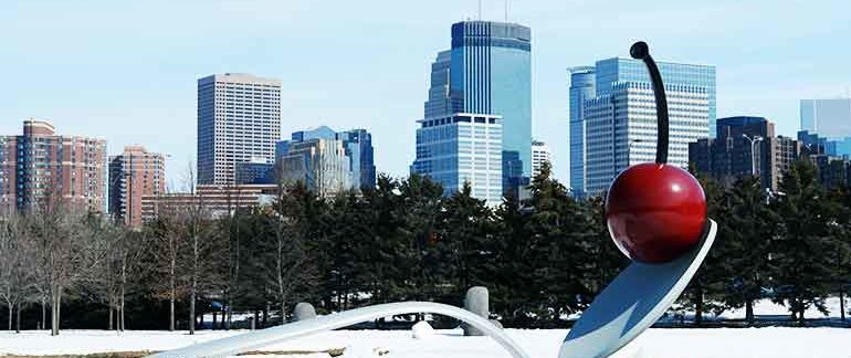 A wintery shot of the Minneapolis skyline, featuring a spoon monument with a cherry on top