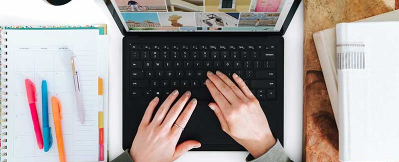 Person typing on a laptop.