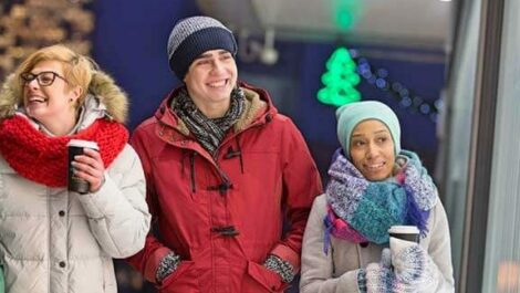 A group of people walk around Chicago bundled up in warm clothing