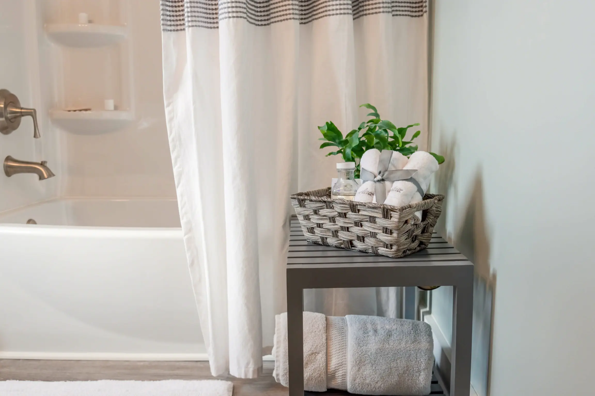 White bathroom with a gray storage shelf in the foreground.