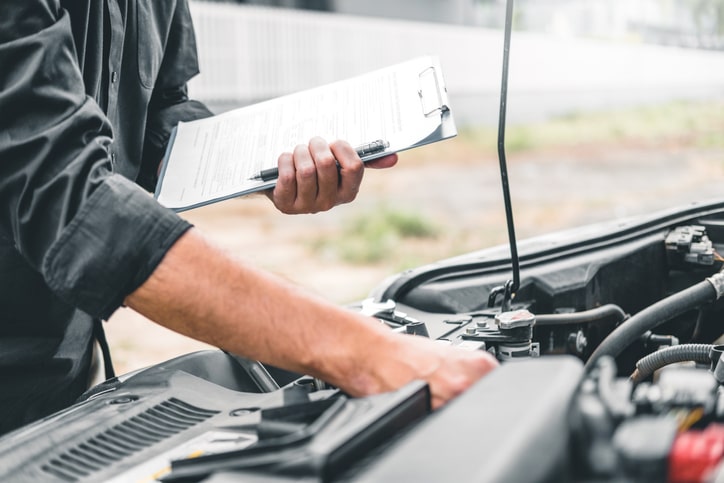 Mechanic performing maintenance on a car.