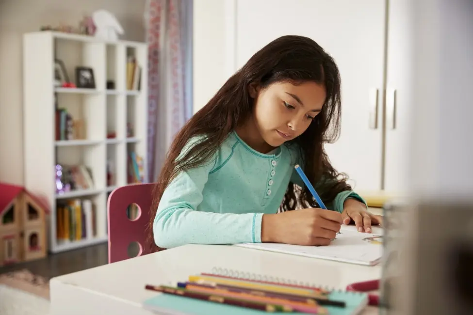 Young girl does homework at a desk