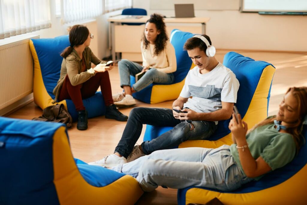 Students sit in comfy chairs in a classroom
