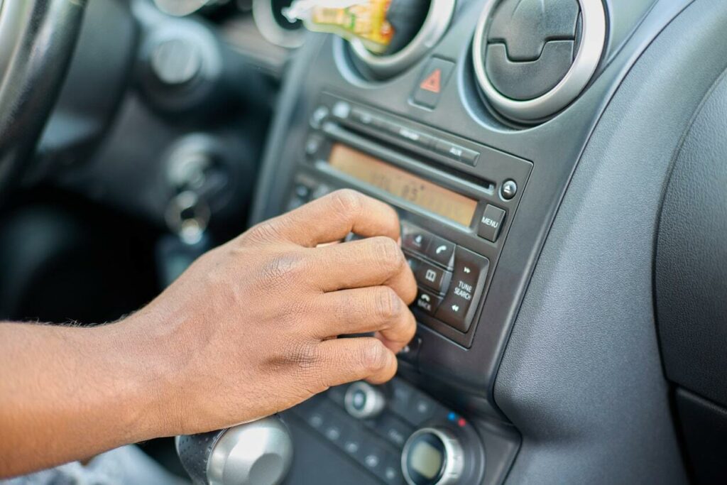 Driver uses dial to turn up the volume on car’s stereo