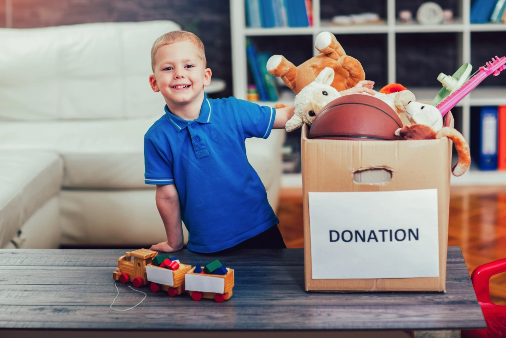 Boy filling donation box with toys