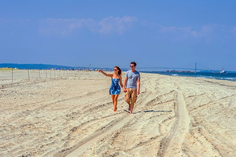 couple walking on New Jersey beach in USA