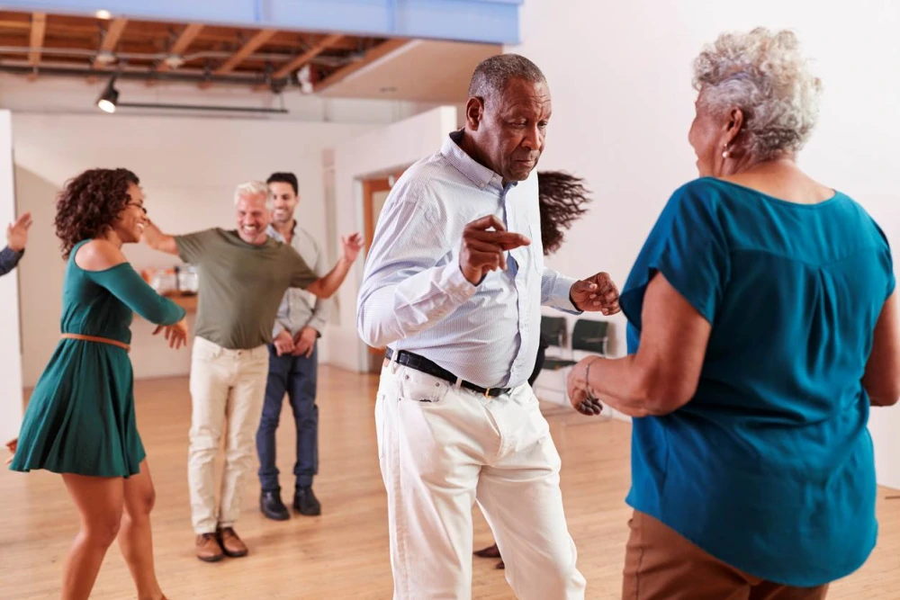 Group of elderly people dancing together at a party.
