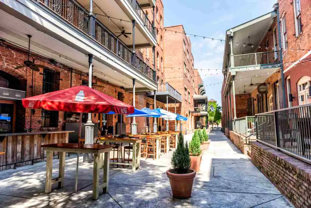 An alley in Montgomery full of restaurants with tables for dining