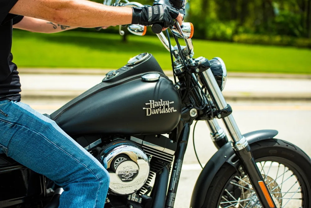 Close up of man on a Harley Davidson motorcycle.