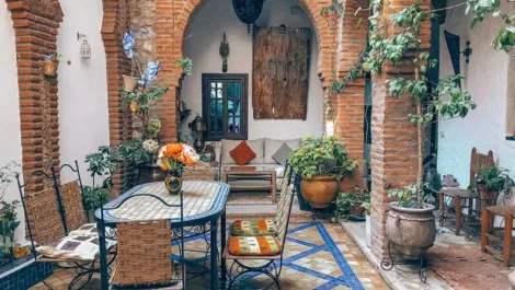 Courtyard-like dining room in a tile-filled room.