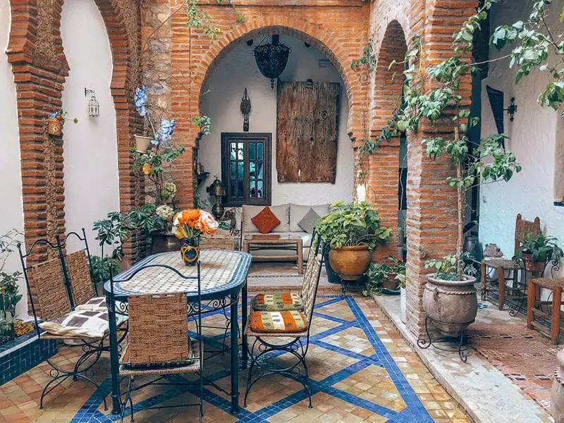 Courtyard-like dining room in a tile-filled room.