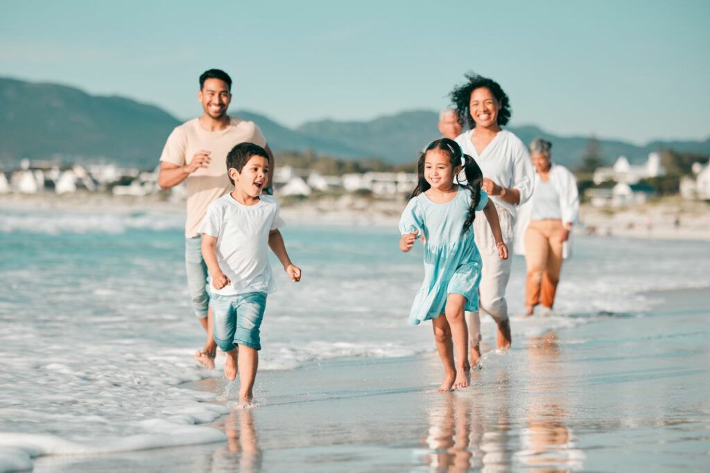 Family running on the beach.