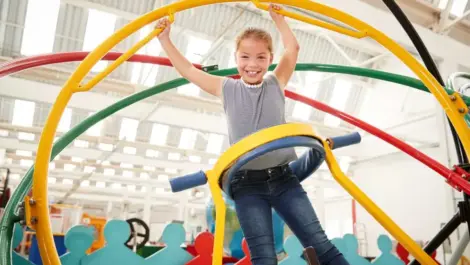 Young girl having fun using a human gyroscope