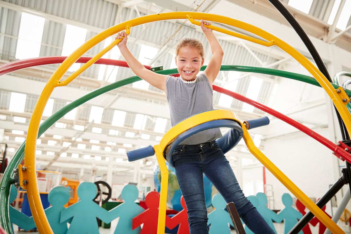 Young girl having fun using a human gyroscope