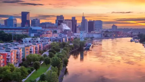 Aerial cityscape image of downtown St. Paul, Minnesota, USA with reflection of the skyline in Mississippi River at beautiful summer sunrise.