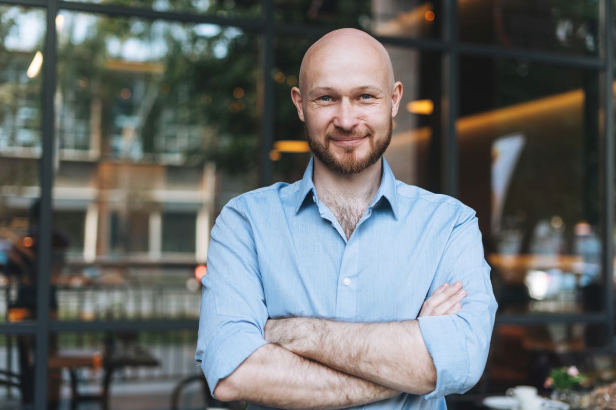 Portrait of Adult smiling man forty cafe