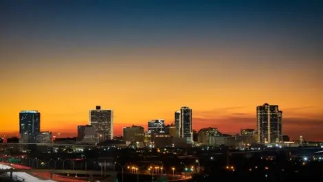 Beautiful evening view of the Fort Worth, TX city with the sun setting in the background.