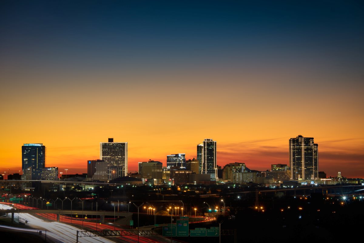 Beautiful evening view of the Fort Worth, TX city with the sun setting in the background.