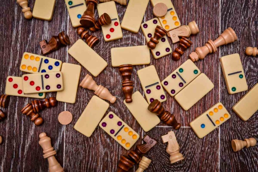 A variety of board game pieces strewn across a wooden table