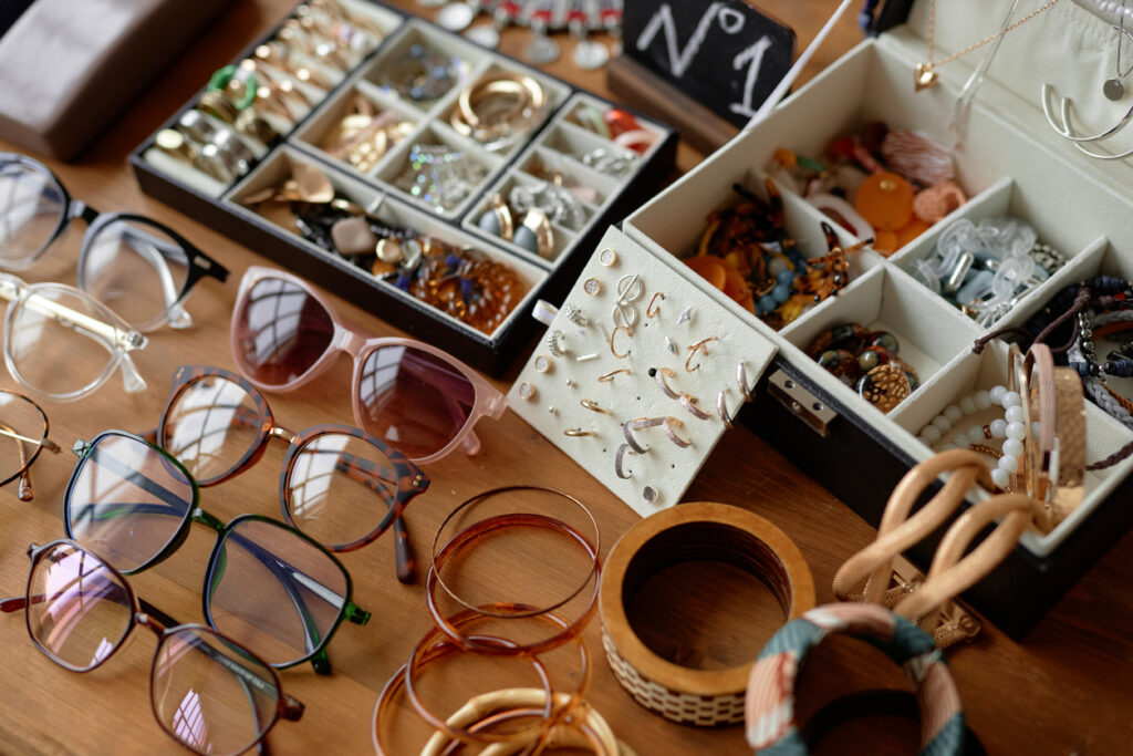 Jewelry and glasses displayed on a table. 